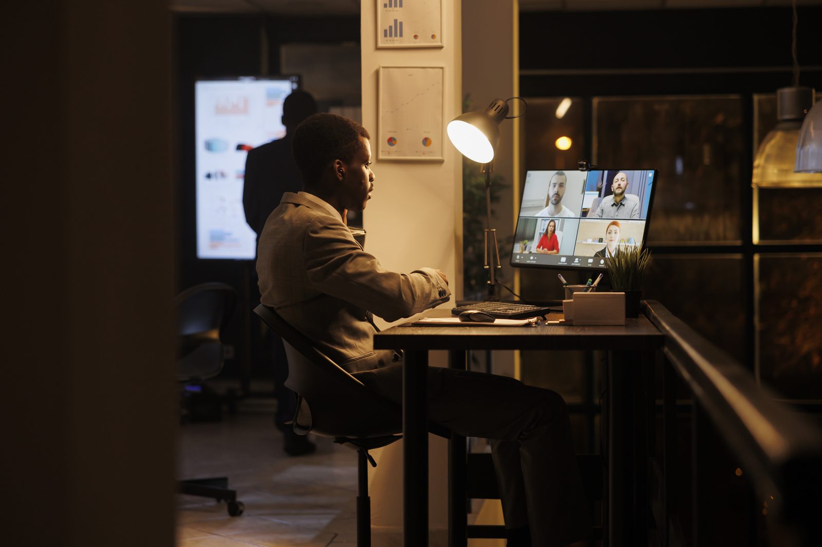A business owner working late reviewing figures on screen