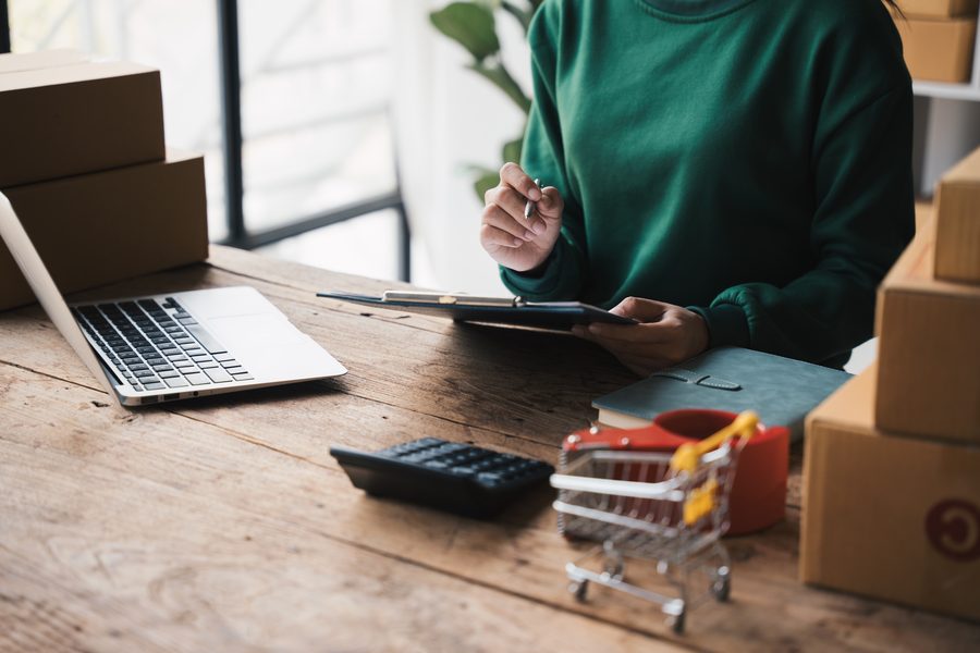 Online seller with parcels and laptop — ecommerce accountancy